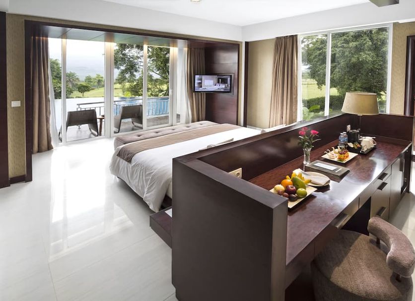 R Hotel Rancamaya Bogor guest room with balcony, garden views, and dining table