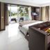 R Hotel Rancamaya Bogor guest room with balcony, garden views, and dining table