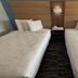 Jacksonville Inn & Suites in Jacksonville guest room with two double beds and bedside table