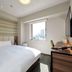 Hearton Hotel Shinsaibashi Nagahoridori room in Osaka with bed, wall-mounted TV and city view