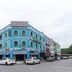 Hotel Suria Malaqa in Malacca, blue corner hotel exterior with parked cars
