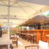 Rooms Smart Luxury Hotel & Beach in Cesme, outdoor bar with stools and thatched-roof terrace