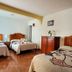 Hotel Posada Camelinas in Pátzcuaro guest room with three beds and wood furniture