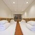 Guanwu Villa in Tai'an Township simple twin room with two single beds and wood-paneled walls