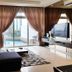 Ksl Hotel & Resort in Johor Bahru living room with sofa, TV, and sliding doors to a pool view