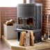 Lodge Koropokkuru in Niseko, wood-burning stove with firewood and fireplace tools