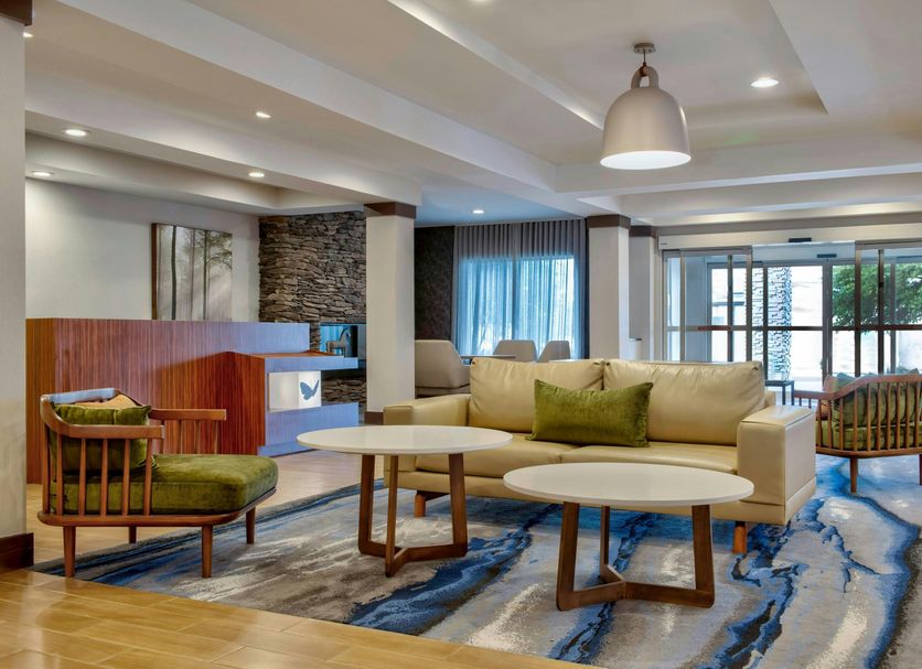 Fairfield Inn & Suites by Marriott Greenwood lobby with seating area, tables, and large windows