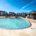 Barrier Island Station in Duck with a large outdoor pool, lounge chairs, and seaside resort buildings