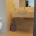 Grand Orchid Hotel Yogyakarta in Depok bathroom with toilet, sink, mirror, and trash bin
