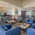 Golden Tulip Canaan Kampala lobby lounge with blue armchairs and dining area in Kampala