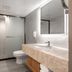 Beijing Hwa Apartment Hotel bathroom with walk-in shower, toilet, and vanity in Beijing