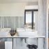 Acta The Avenue in Porto bathroom with double sinks and city view through large window