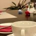 Hotel Friedrichstraße Lampertheim dining table with white cup, plates, and folded napkins