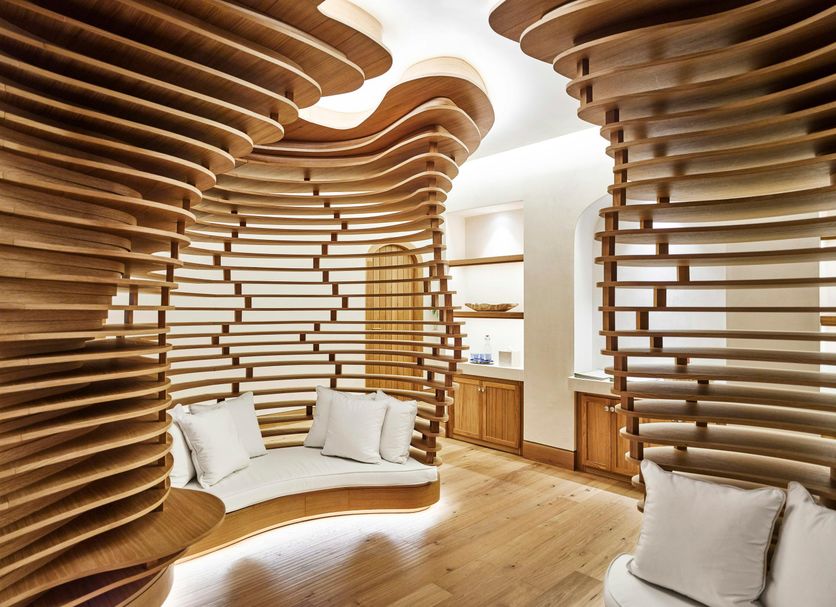Nobu Hotel Marbella in Marbella, sculptural wooden lounge seating with curved slatted walls