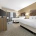 Best Western Brockport Inn & Suites guest room with two beds, TV and window view in Brockport