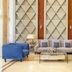 Golden Tulip Canaan Kampala lobby seating area with blue chairs and sofa in Kampala