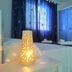 Camere D'Aragona Otranto guest room with lit bedside lamp, twin beds, and blue curtains