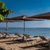 Kejora Suites beach loungers and umbrellas facing the ocean in Denpasar