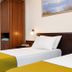Sun City Hotel in Tel Aviv guest room with two single beds, desk, mirror, and wardrobe