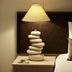 Berkeley River Lodge bedside table with sculptural lamp and pillows on bed, Berkeley River