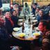 Guests dining at a long communal table at El Cafecito Hostel Cuenca in Cuenca