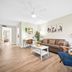 Riverwatch Apartments By Lowkl in Jensen Beach living room with sofa, blue chair and dining area
