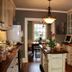 Williamsburg Manor B&B kitchen with island, built-in cabinets, and dining area in Williamsburg