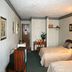 Yarmouth Resort West Yarmouth guest room with two beds, TV, desk and dining area