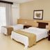Hotel Steinhausen Blumenau guest room with two single beds and balcony doors