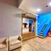 Hotel Porto Salvador in Salvador lobby with blue staircase, seating area, and reception desk
