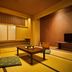 Ooedo Onsen Monogatari Dogo in Matsuyama: Japanese-style tatami room with low table and futon seating