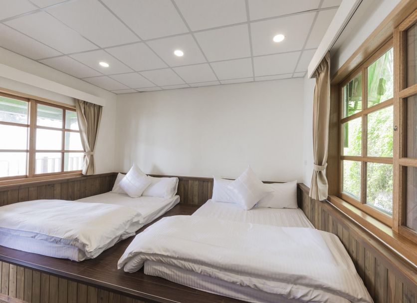 Guanwu Villa in Tai'an Township guest room with two twin beds and large windows with natural light