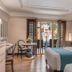 Henann Regency Resort & Spa Boracay room with balcony doors, king bed, and poolside view
