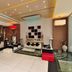 Hotel Vijay Parkinn, Coimbatore lobby with seating area, modern ceiling lights, and decorative wall art