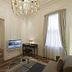 The Stay Galata in Istanbul guest room with chandelier, TV, glass coffee table and tall window
