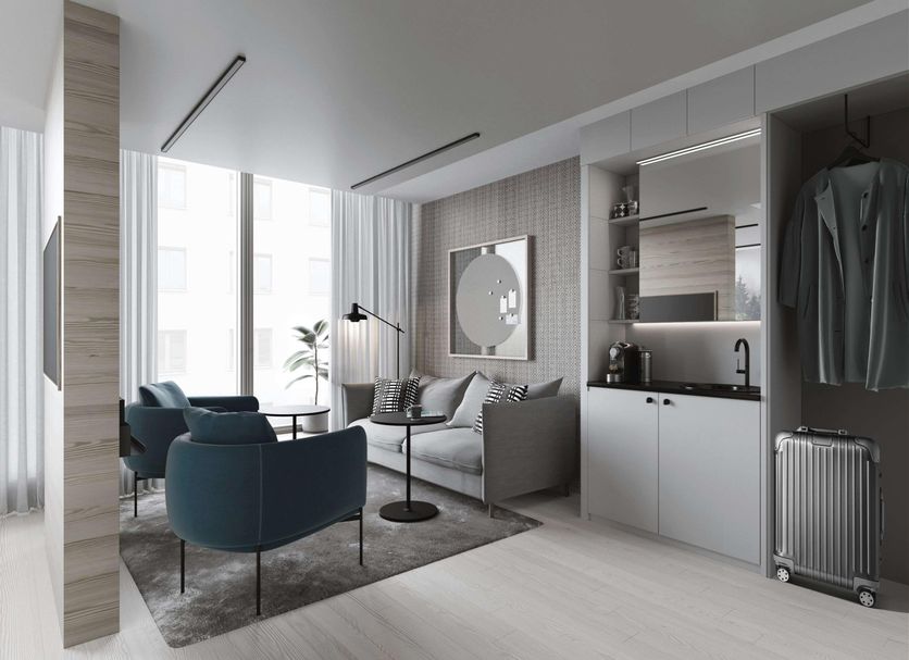 Valo Hotel & Work Helsinki room with seating area, kitchenette, and clothing storage in Helsinki