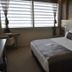 Orty Airport Hotel in Izmir guest room with tufted headboard, king bed, and window blinds