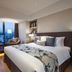 Somerset Xindicheng Xi'an hotel room with king bed, city view balcony, and seating area in Xi'an