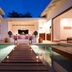 Ka'ana Resort in San Ignacio: elegant courtyard plunge pool with candlelit wooden walkway and lounge area
