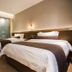 James Joyce Coffetel San Yuan LI Station Guangzhou twin-bed guest room with warm lighting
