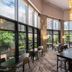 Grand Millennium Kuala Lumpur lounge with floor-to-ceiling windows and long communal table in Kuala Lumpur
