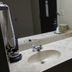 Briarwood Inn Sparta bathroom sink vanity with mirror, towels, tissue, and coffee setup