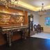 The Park Residence in Bangkok lobby with ornate carved fireplace, chandeliers, clock and seating area