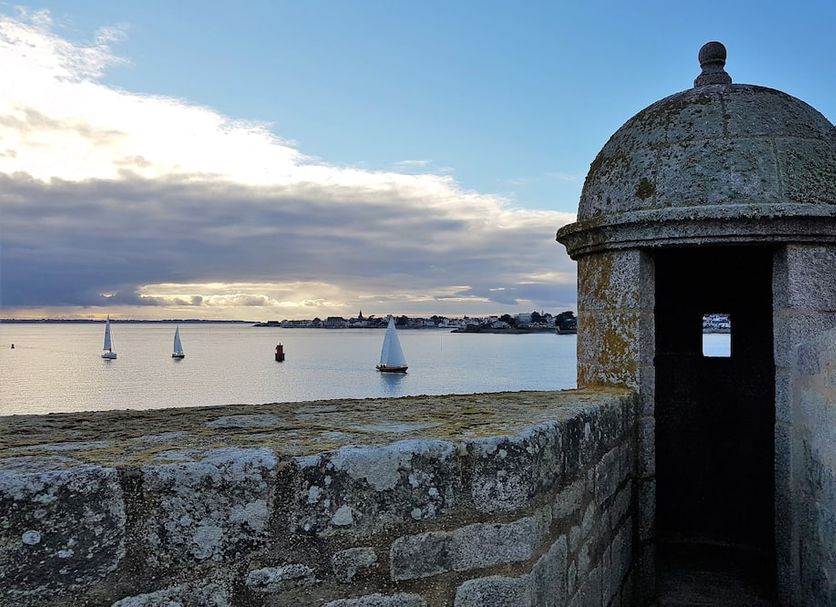 Hôtel Spa De La Citadelle Lorient in Port-Louis, stone fort wall overlooking harbor sailboats at sunset