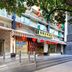 Yanjiang East Garden Inn in Guangzhou exterior with striped awning, red lanterns and sidewalk entrance