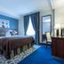 Hotel Restaurant Famille Bourgeois, Sancerre: blue hotel room with double bed, desk, chair, and curtain-covered window