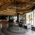 Quentin Boutique Hotel Berlin lobby with ornate wood ceiling, patterned floor and seating area