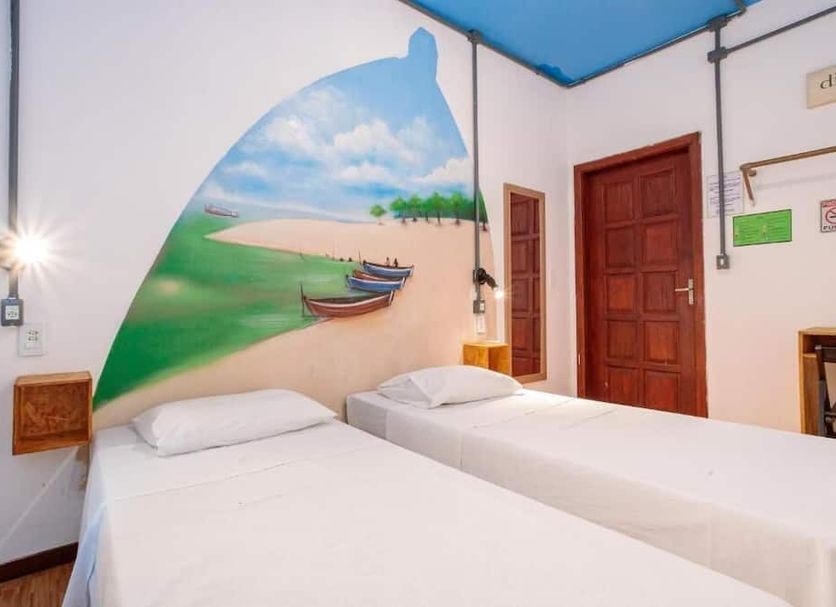 Local Hostel Manaus twin room with colorful mural and two beds in Manaus