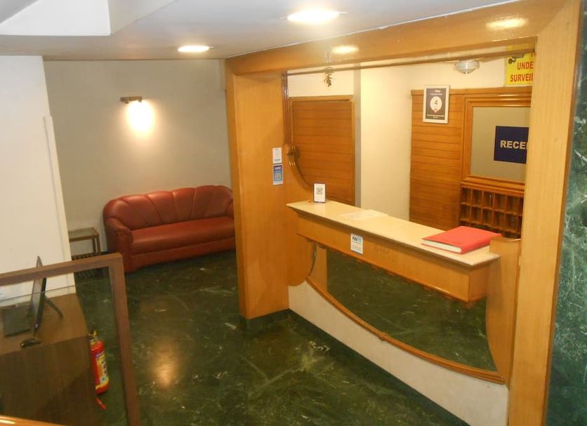 Hotel Pooja International Nashik reception desk and lobby seating area