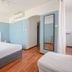 Abrivado in Saintes-Maries-de-la-Mer guest room with king bed, wood floor and wall mirror